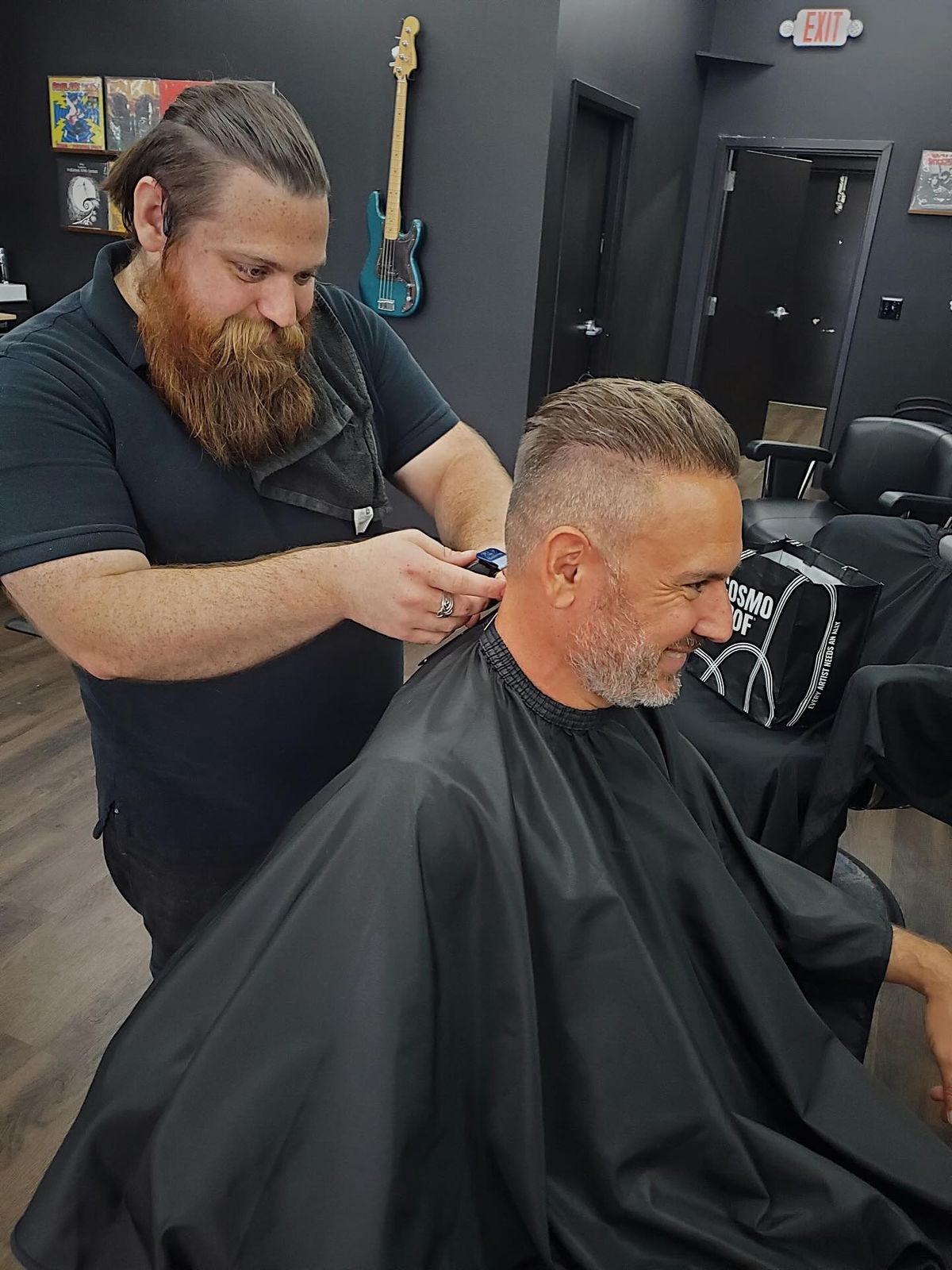 Bearded Hawk & Fade barber shaping a client's haircut with clippers